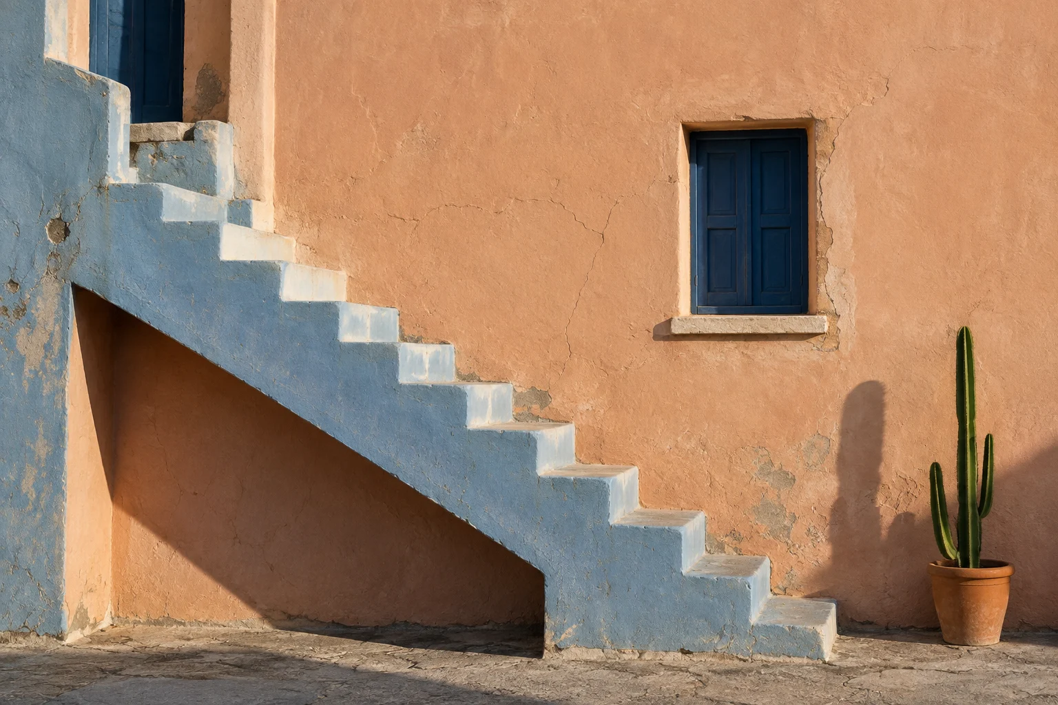 A minimalist pastel-blue concrete staircase against a warm peach wall in hard daylight.