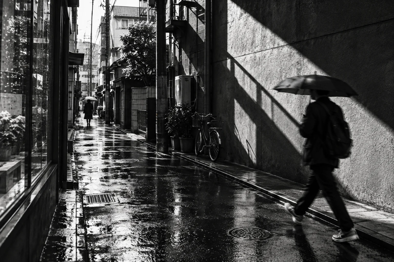 A candid black-and-white city scene with strong shadows, movement, and visible film grain.